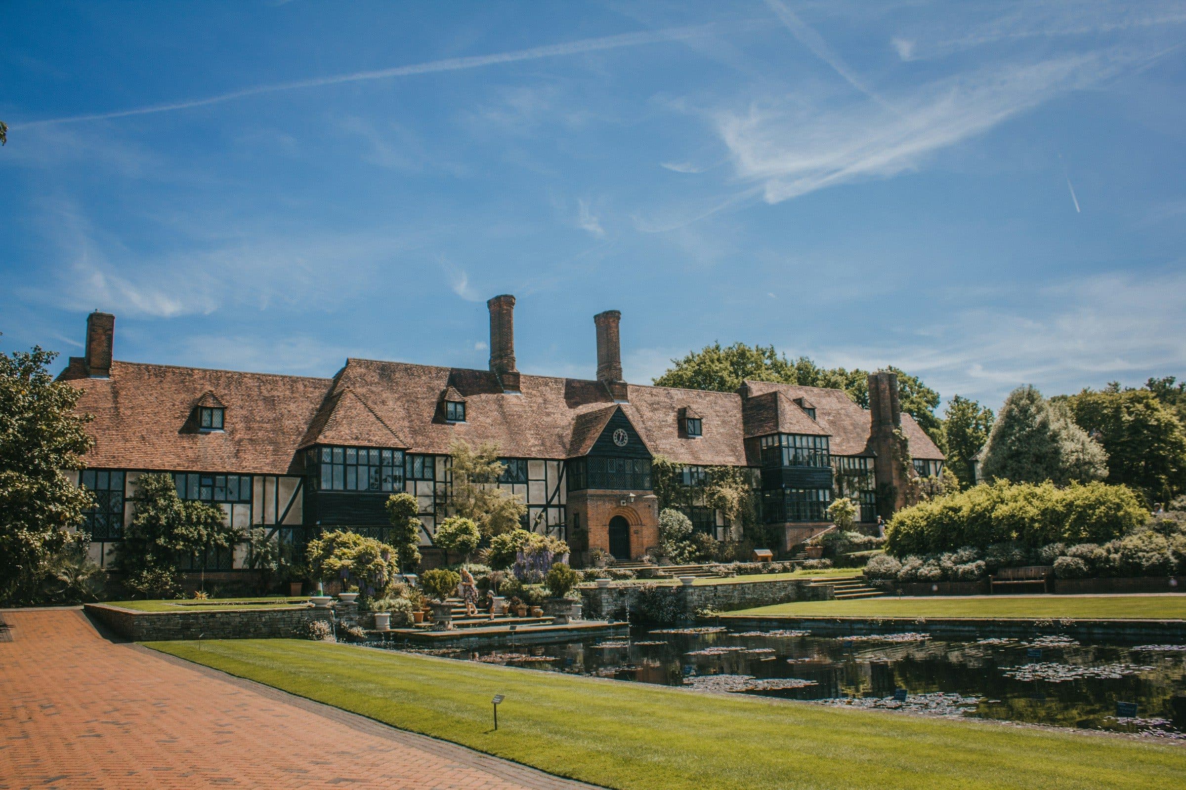 Timber-framed manor house beside a pond