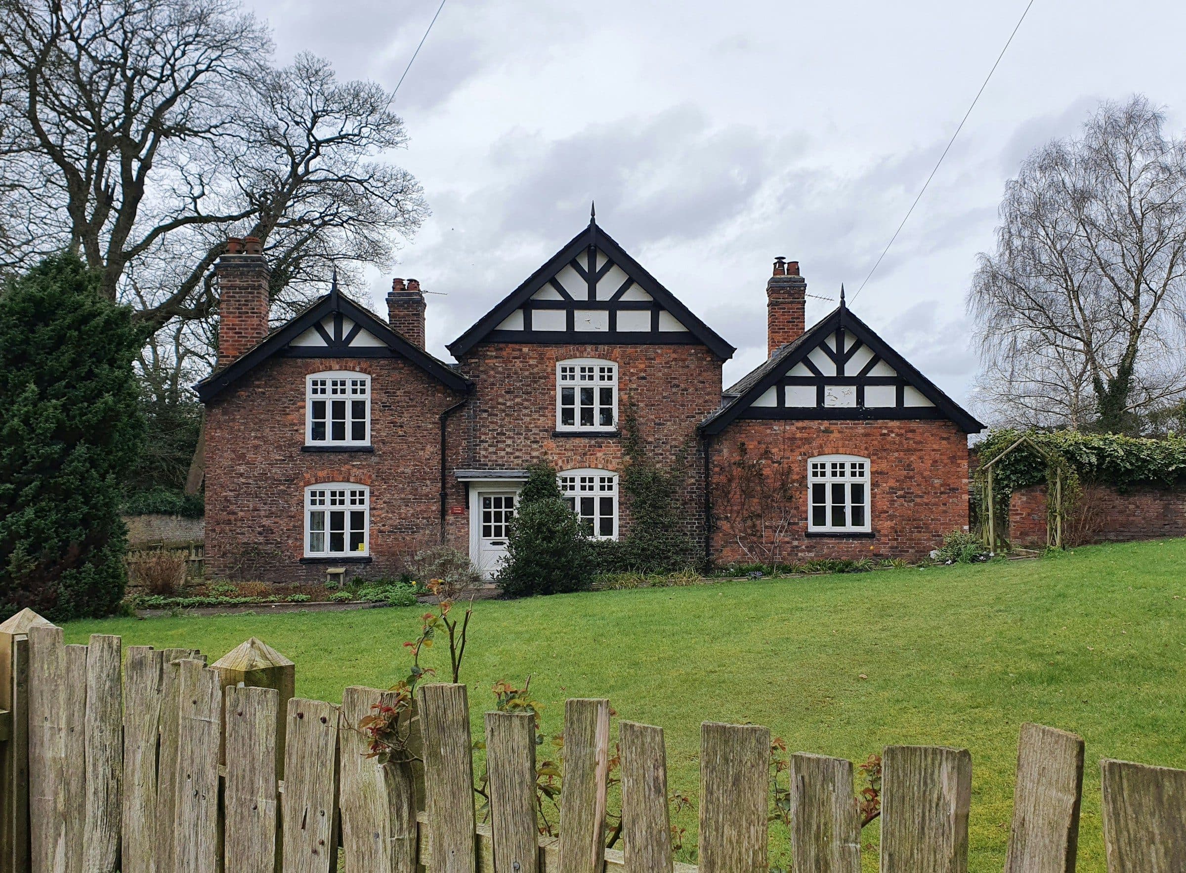 Red-brick gabled cottages on a village green